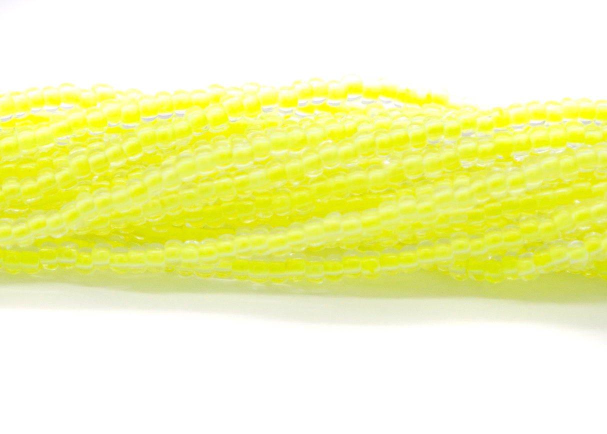 8SB723-N: CZ Seed Bead Neon Lined Yellow 8/0 UV Reactive 6HK