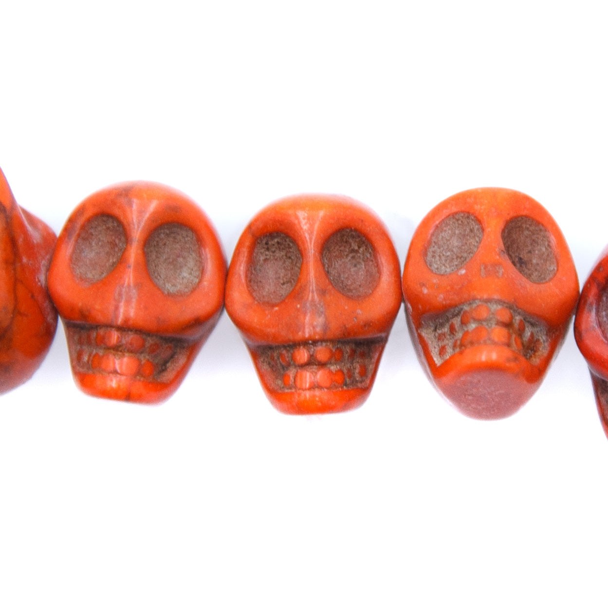 6ST50-O: 14x10mm Orange Magnesite Skull Beads 15.5"