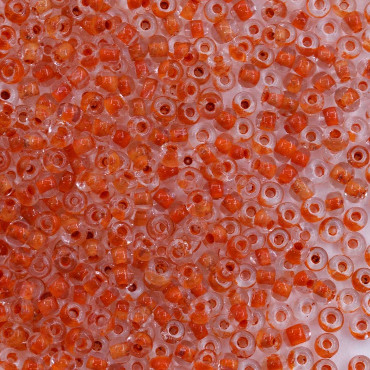 10SV734: Antique Venetian 10/0 Seed Bead Clear Orange - 10 Grams