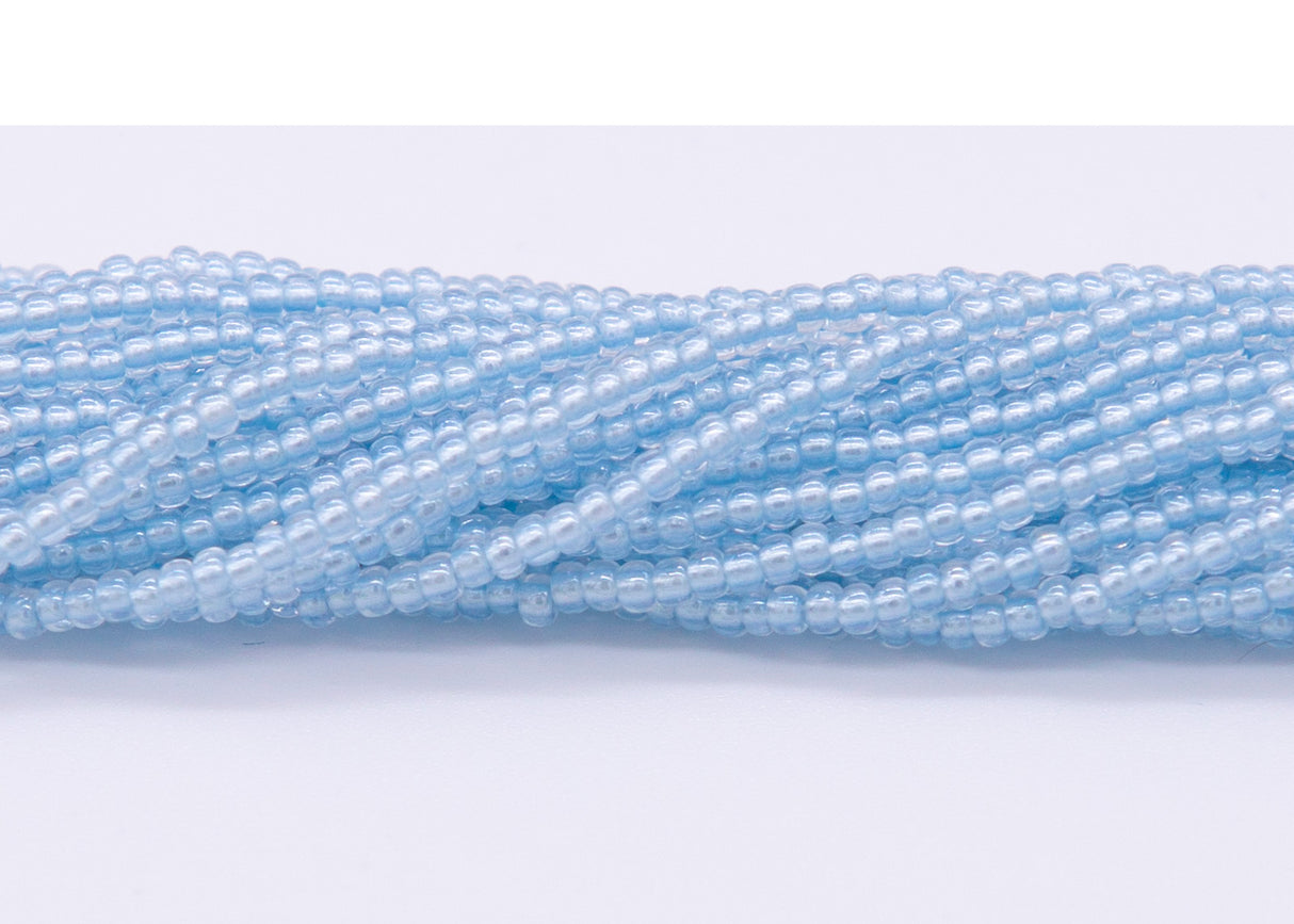 10SB672-LPR: CZ Seed Bead Patel Pearl Lined Sapphire 10/0-1HK