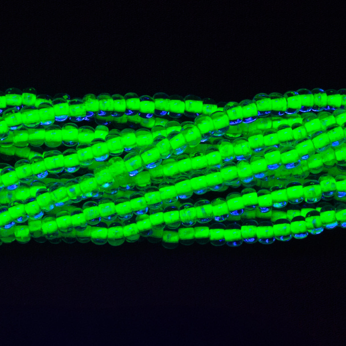 6SB784-N: CZ Seed Bead Neon Lined Green 6/0 Uv Reactive 36STR